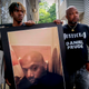 Armin Prude, left, and Joe Prude hold an enlarged photo of Daniel Prude, Sept. 3, 2020, who died following a police encounter, in Rochester, N.Y. City officials have agreed to pay $12-million to the family of Daniel Prude, a Black man who died after police held him down until he stopped breathing after encountering him running naked through the snowy streets of Rochester, NY. A federal judge approved the settlement in a court document filed Thursday, Oct. 6, 2022.